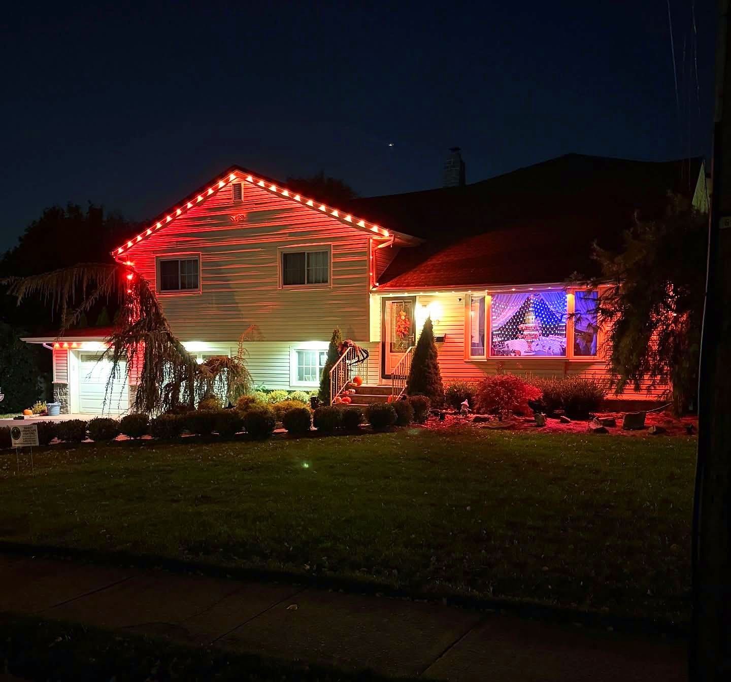 Split level home with a red permanent roofline strip