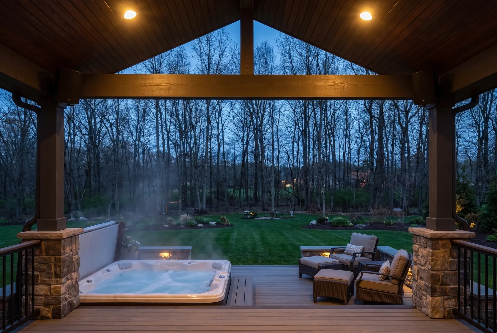 Covered backyard deck at dusk with outdoor speakers under the roof, a setup we install across Long Island
